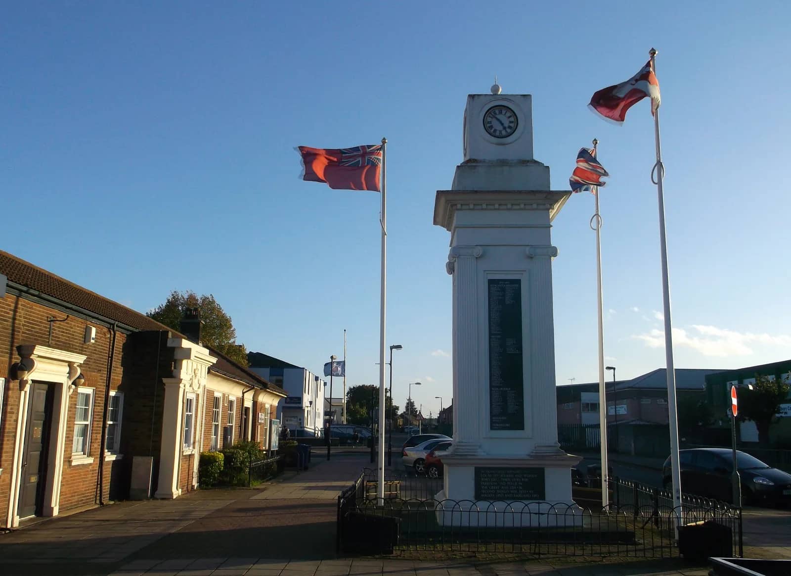 The clock tower war memorial in Civic Square, Tilbury, with flags flying beside it