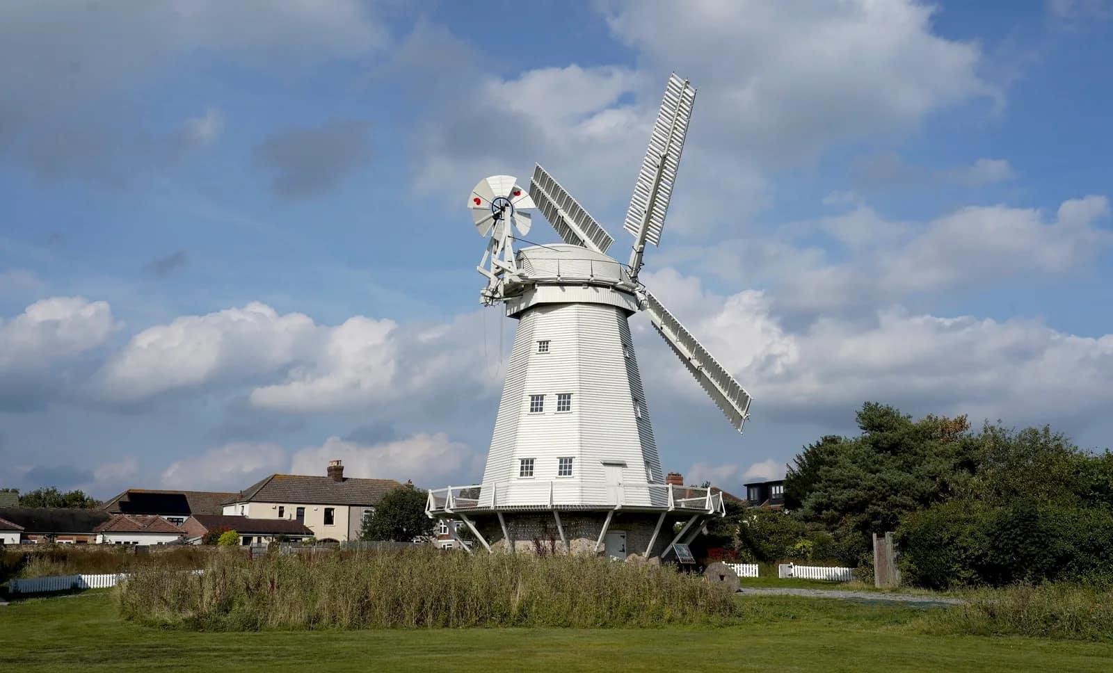 Upminster Windmill, a white smock mill built in 1803, with houses behind it