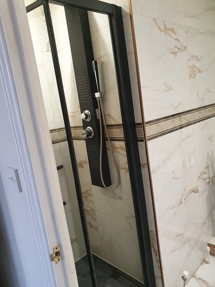 Bathroom install with marble-effect tiling — Bathroom Fitting by Emir Handyman in Essex & East London